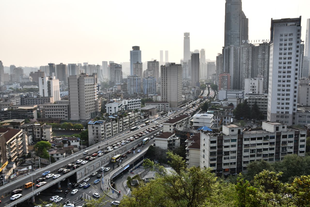 Vibrant cityscape showcasing a bustling urban environment with high-rise buildings and heavy traffic.